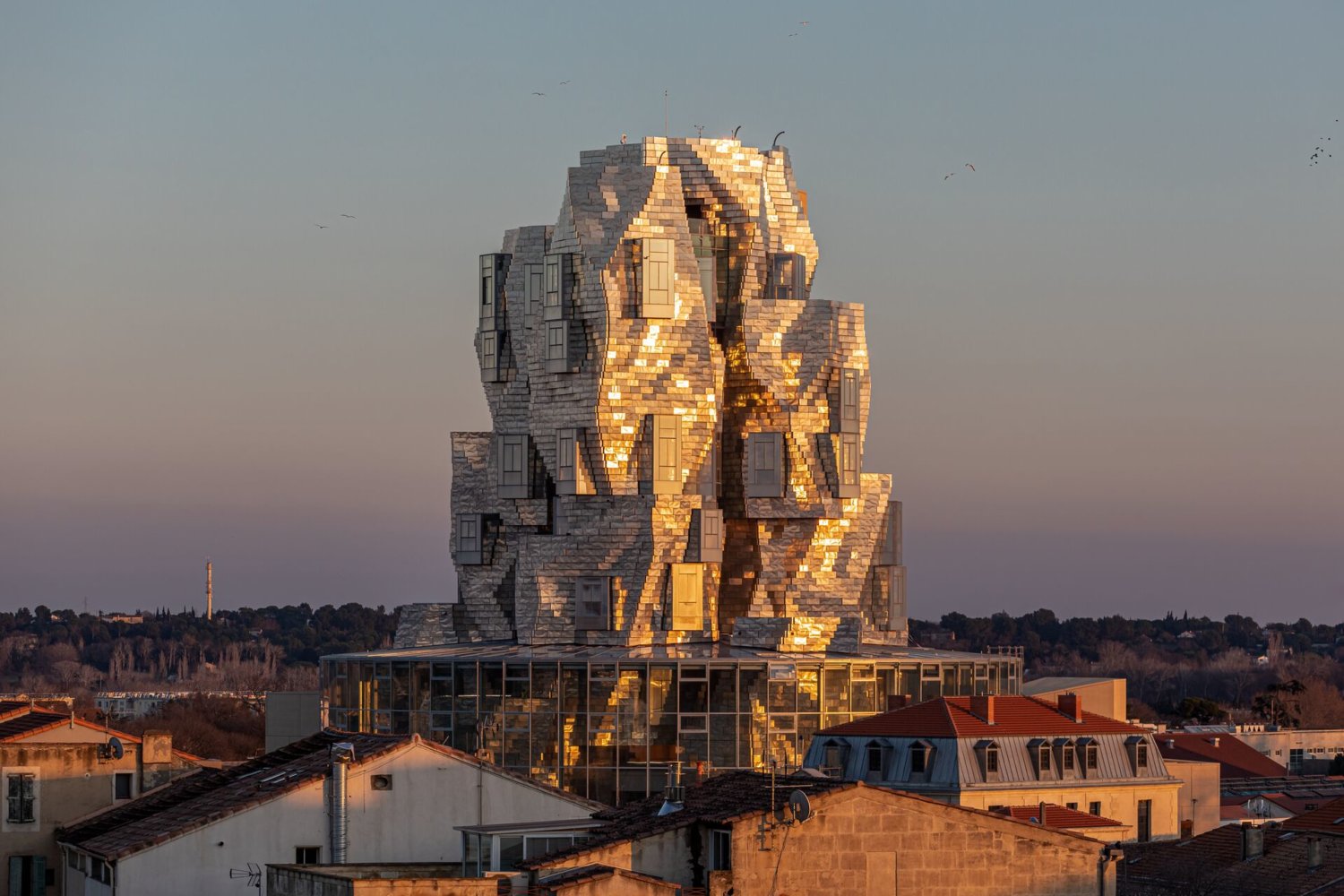 Ein Turm von Frank Gehry im Sonnenuntergang.